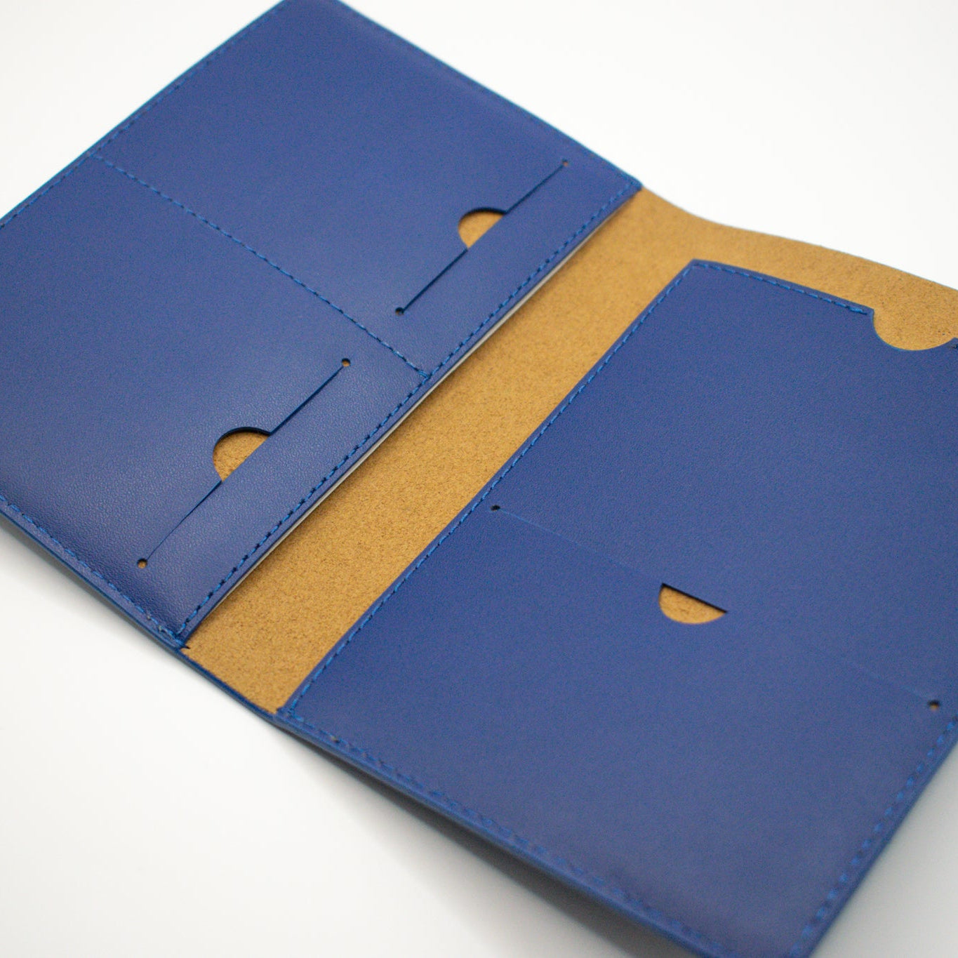Blue leather wallet with brown interior on a white background