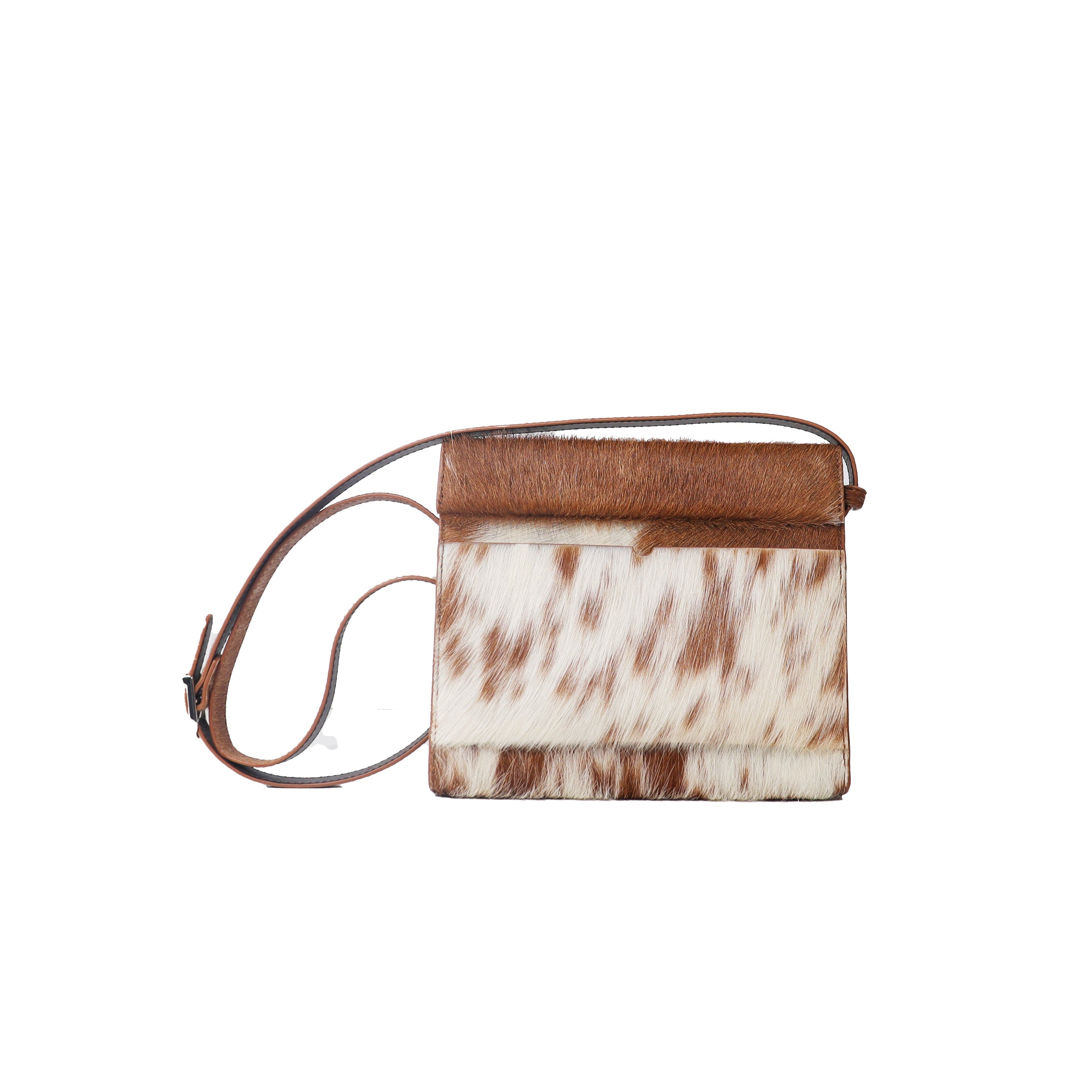 Small handbag with cow print design on a white background