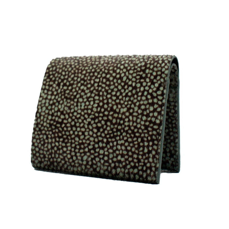 hair on textured bifold walelt with green dots on brown on a white background