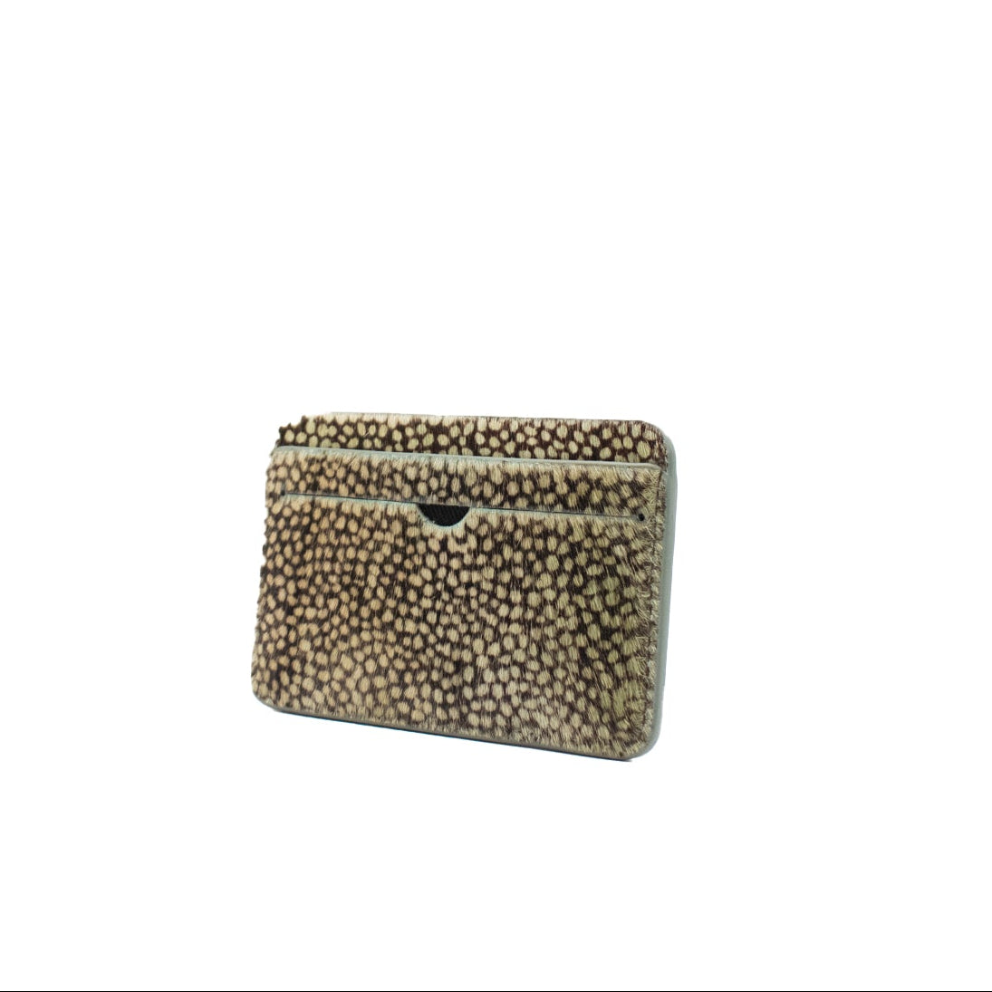 Small rectangular cardholder made of cowhair in a dot pattern with a textured pattern on a white background