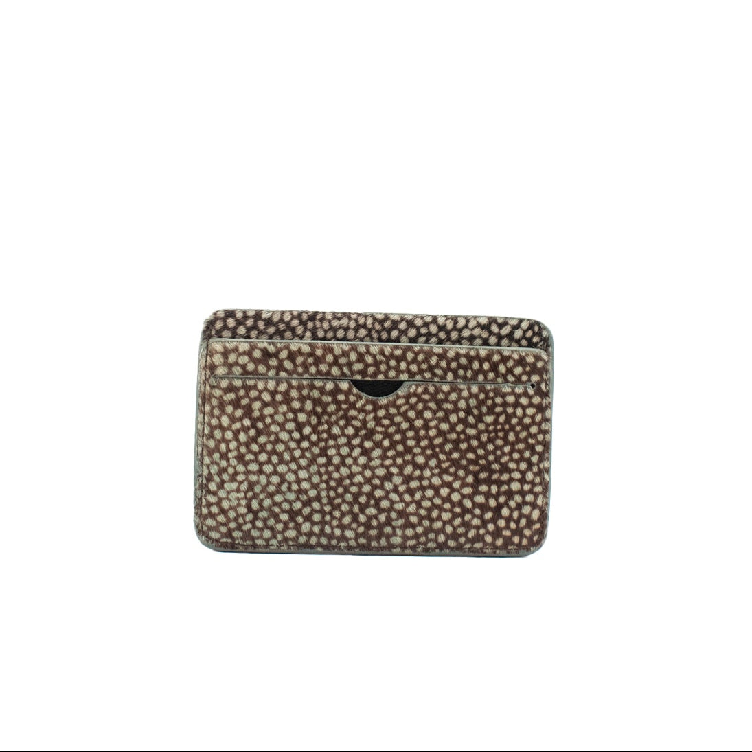 Small rectangular cardholder made of cowhair in a dot pattern with a textured pattern on a white background