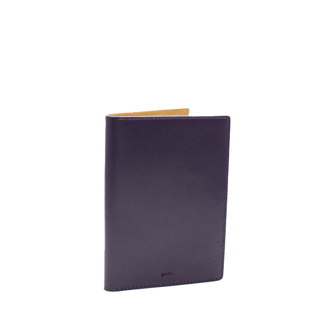 Purple leather passport cover on a white background