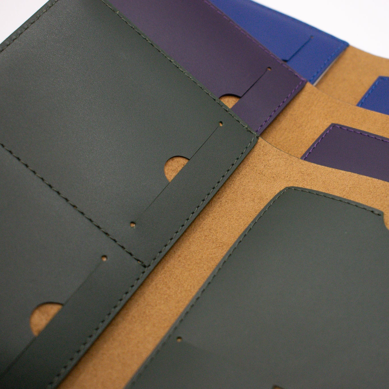 Close-up of leather passport cover with different color covers on a white background